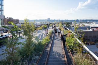 People walking and balancing on railways